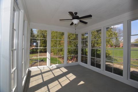 Rear porch with EZE-BREEZE vinyl 4 track window system