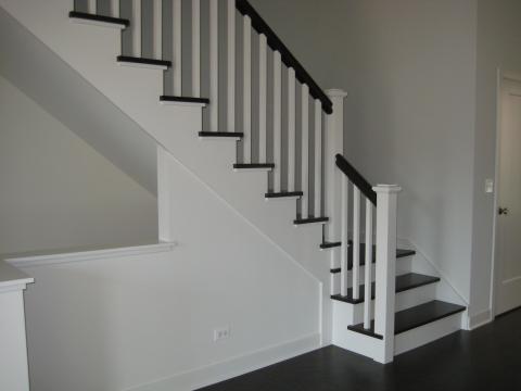 Custom stair with stained treads and hand rail with painted spindles and risers