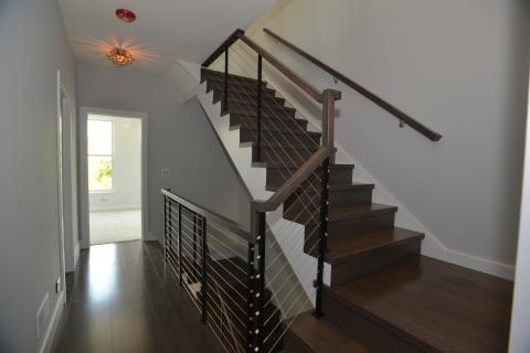 Custom stair with cable railing system and stained treads and risers