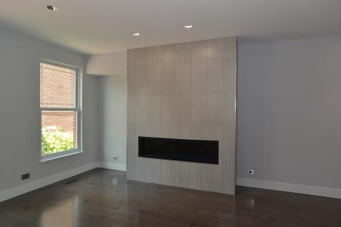 Modern linear fireplace with tile face and no mantle