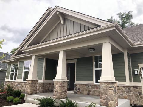 Front porch with craftsman style stone and wood columns