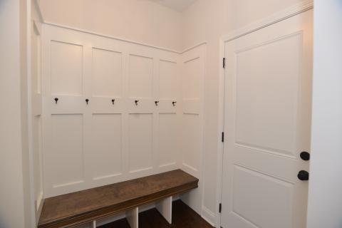 Mudroom boot bench with hooks and shaker paneling