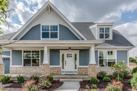 Front porch- James Hardie shingle siding in gable, cultured stone water table and columns