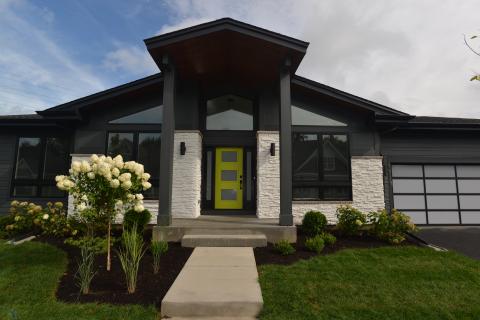 Modern front porch, stone and siding exterior with opaque glass garage door